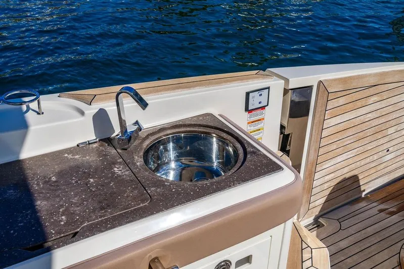 Sobe III Yacht Photos Pics Luxury 2019 Sea Ray SLX 400 Outboard boat with sleek outdoor sink and wooden deck.
