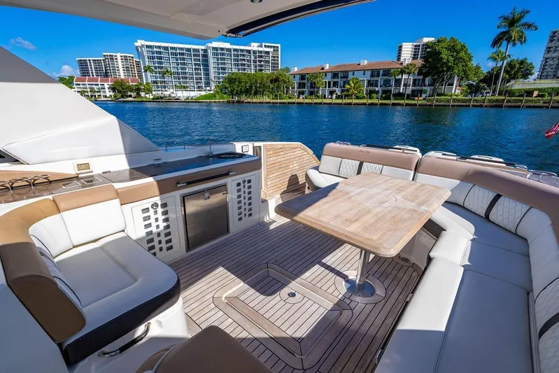 Sobe III Yacht Photos Pics Luxurious 2019 Sea Ray SLX 400 Outboard boat interior with seating and table, docked by waterfront.