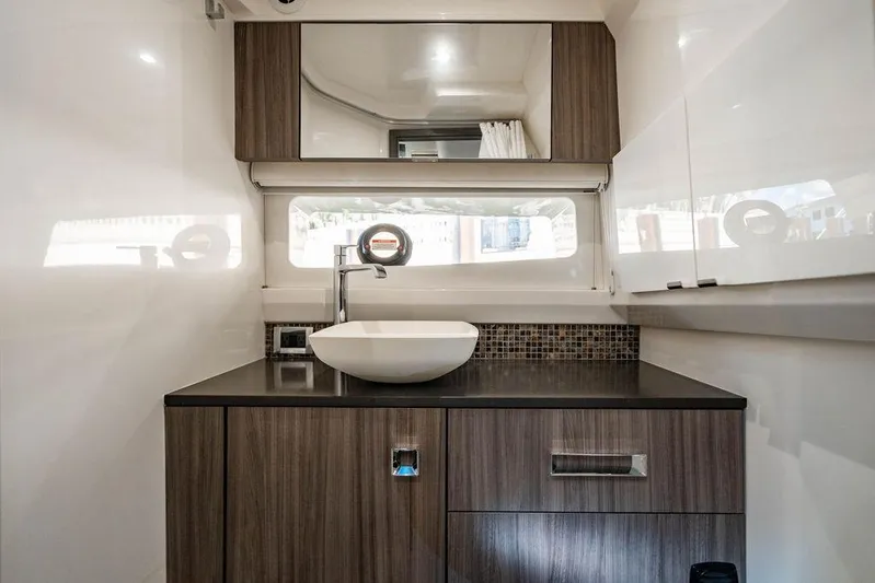 Sobe III Yacht Photos Pics Luxurious bathroom interior of 2019 Sea Ray SLX 400 Outboard yacht, featuring modern sink and cabinetry.