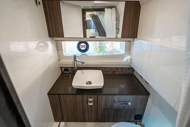 Sobe III Yacht Photos Pics Luxurious bathroom interior of 2019 Sea Ray SLX 400 Outboard yacht with modern sink and cabinetry.