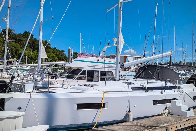 Her Intentions Yacht Photos Pics Jeanneau Sun Odyssey 440 sailboat docked at marina, 2021 model, clear blue sky.