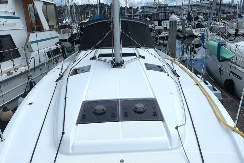 Her Intentions Yacht Photos Pics Jeanneau Sun Odyssey 440, 2021 model, docked in a marina with surrounding boats.