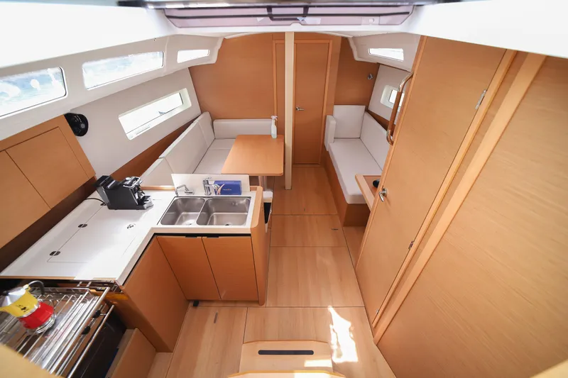Twenty One Cent Yacht Photos Pics Interior of 2022 Jeanneau Sun Odyssey 380 yacht, featuring modern kitchen and seating area.