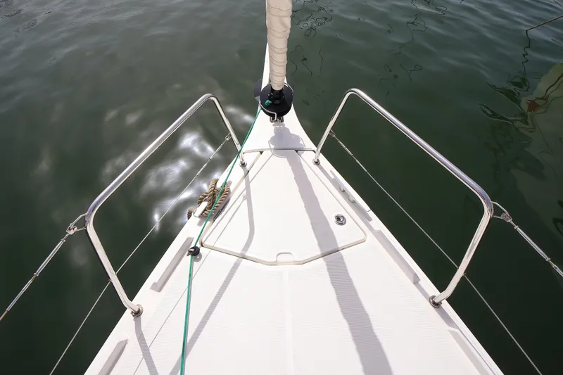 Twenty One Cent Yacht Photos Pics Bow of 2022 Jeanneau Sun Odyssey 380 sailboat on calm water.