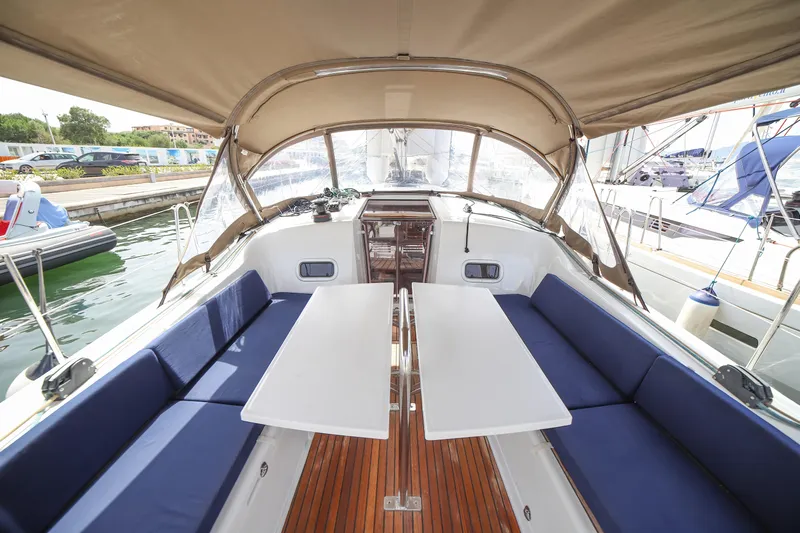 Twenty One Cent Yacht Photos Pics Interior view of 2022 Jeanneau Sun Odyssey 380 sailboat with seating and tables.