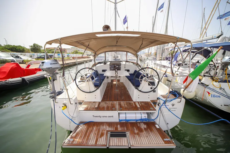 Twenty One Cent Yacht Photos Pics 2022 Jeanneau Sun Odyssey 380 sailboat docked, featuring dual steering wheels and a spacious cockpit.