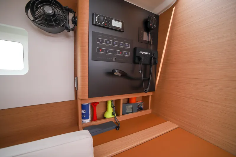Twenty One Cent Yacht Photos Pics Interior of 2022 Jeanneau Sun Odyssey 380 yacht with control panel and fan.