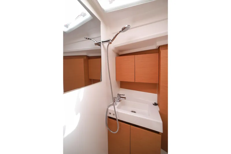Twenty One Cent Yacht Photos Pics Bathroom interior of 2022 Jeanneau Sun Odyssey 380 yacht, featuring modern sink and shower.