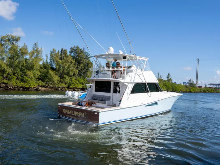 Samurai Yacht Photos Pics 1998 Viking 58 Convertible yacht cruising on a scenic waterway.