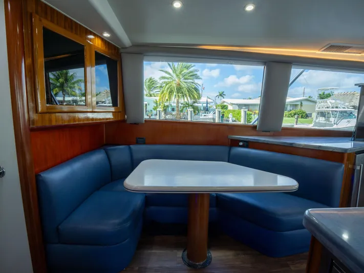 Samurai Yacht Photos Pics Interior of 1998 Viking 58 Convertible yacht with blue seating and table.