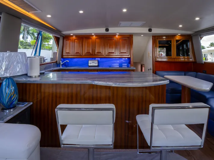 Samurai Yacht Photos Pics Luxurious interior of a 1998 Viking 58 Convertible yacht with modern kitchen and seating area.