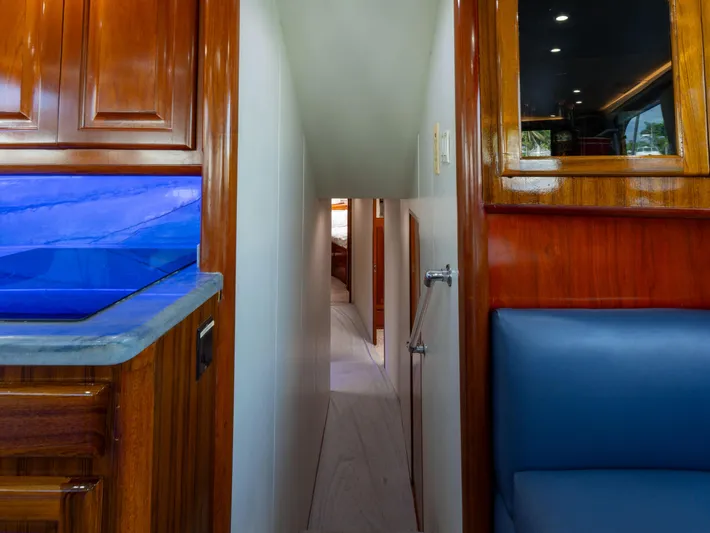 Samurai Yacht Photos Pics Interior view of 1998 Viking 58 Convertible yacht with wood finishes and blue seating.