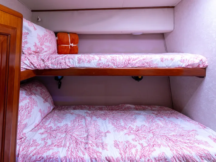 Samurai Yacht Photos Pics Bunk beds with coral-patterned bedding in a 1998 Viking 58 Convertible yacht cabin.