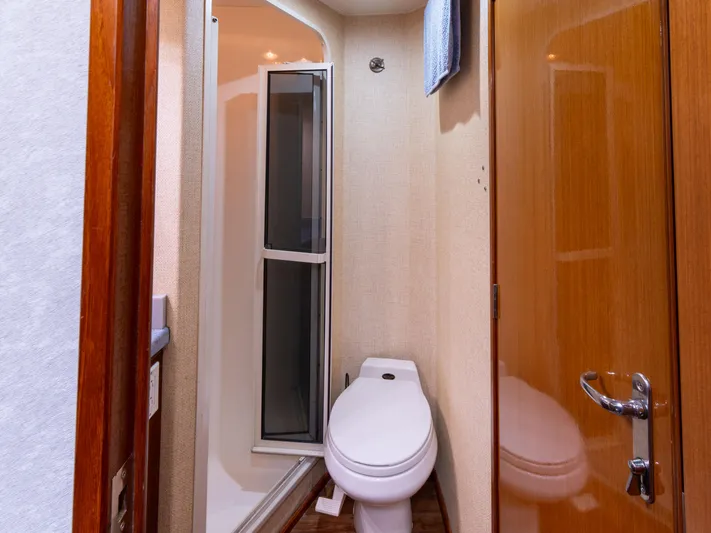 Samurai Yacht Photos Pics Bathroom interior of 1998 Viking 58 Convertible yacht with shower and toilet.