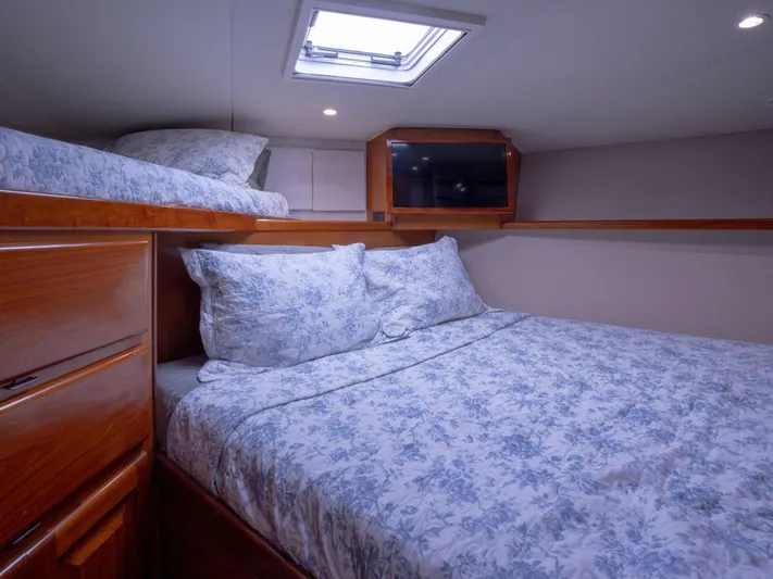 Samurai Yacht Photos Pics Cozy bedroom in 1998 Viking 58 Convertible yacht with floral bedding and wooden cabinetry.