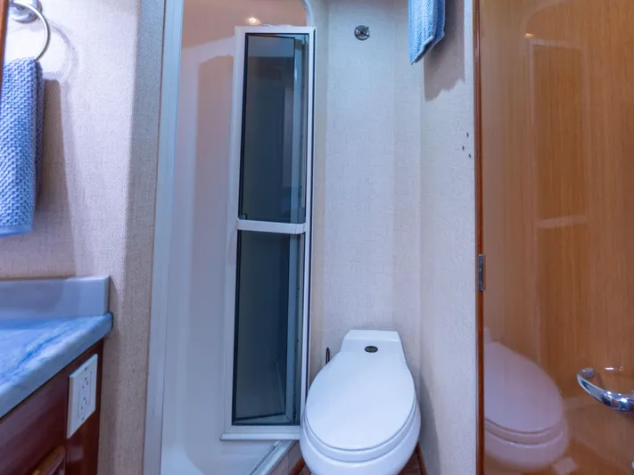 Samurai Yacht Photos Pics Bathroom interior of 1998 Viking 58 Convertible yacht, featuring shower and toilet.