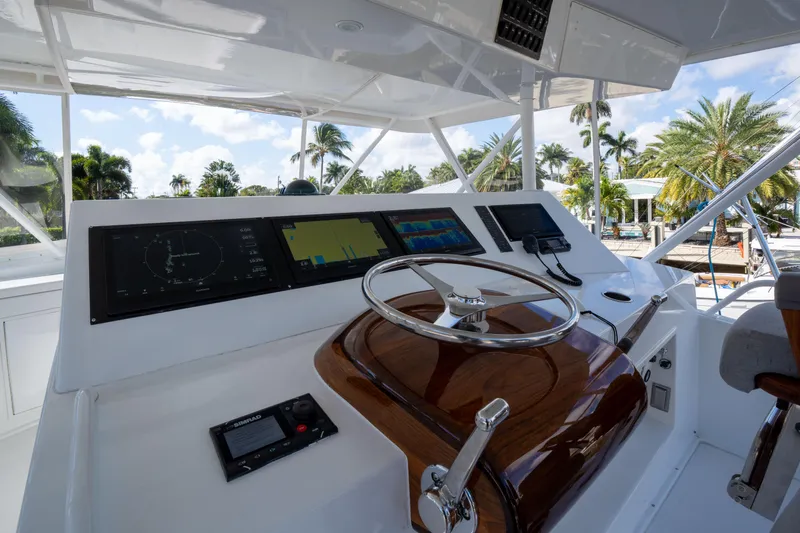 Samurai Yacht Photos Pics Helm of 1998 Viking 58 Convertible yacht with modern navigation equipment and wooden steering wheel.