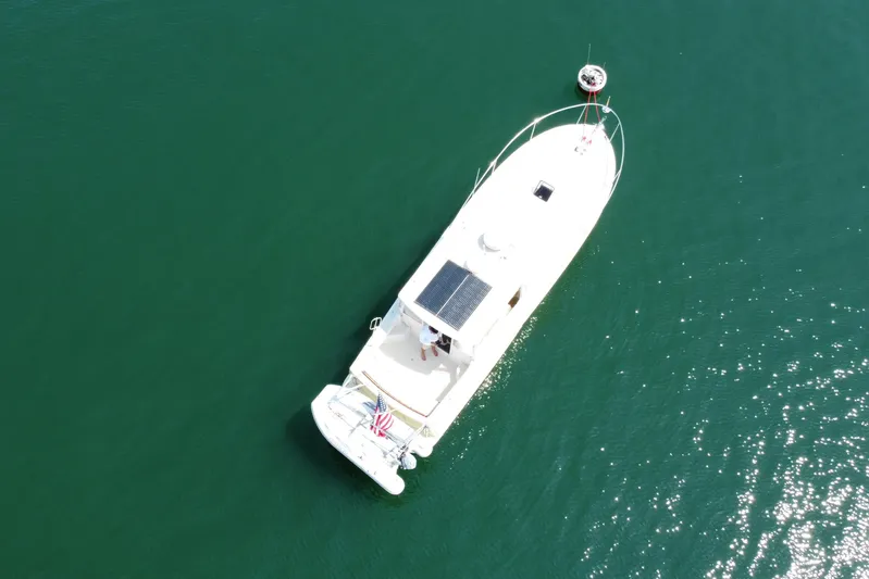 Tango Yacht Photos Pics Aerial view of 2006 MJM 34z Downeast boat on calm green water.