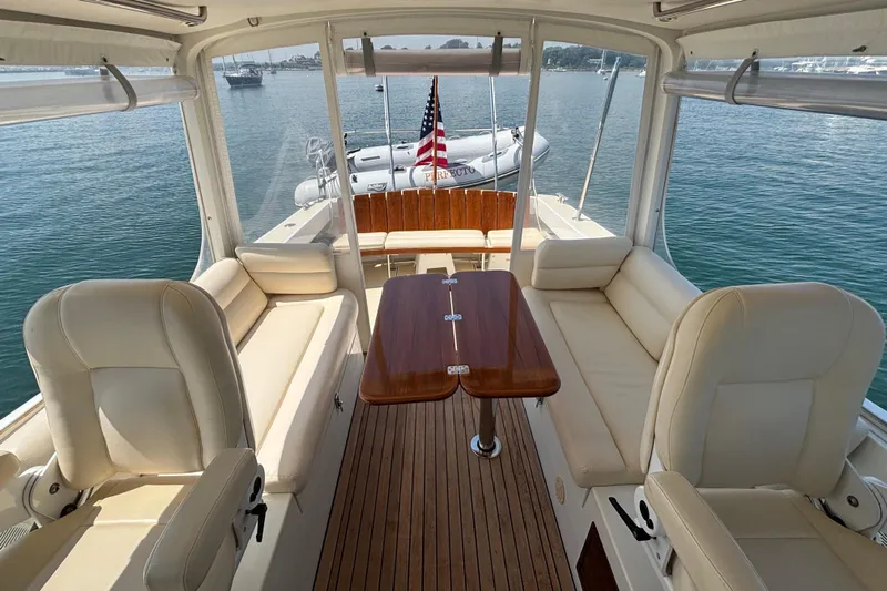 Tango Yacht Photos Pics 2006 MJM 34z Downeast boat interior with seating and table, overlooking calm waters.