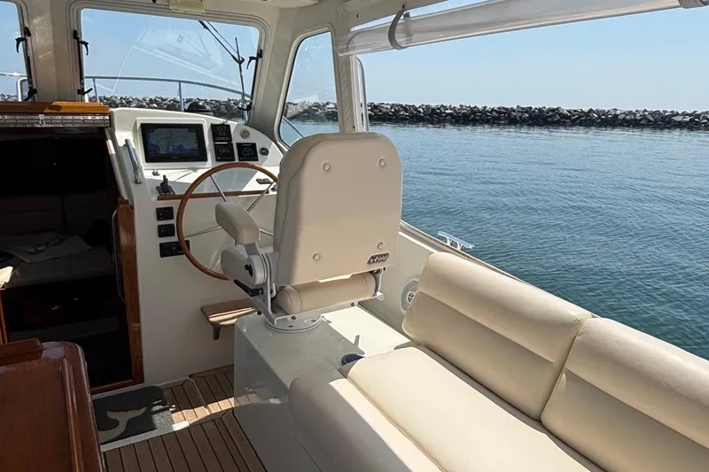 Tango Yacht Photos Pics Interior view of 2006 MJM 34z Downeast boat with helm and seating area.