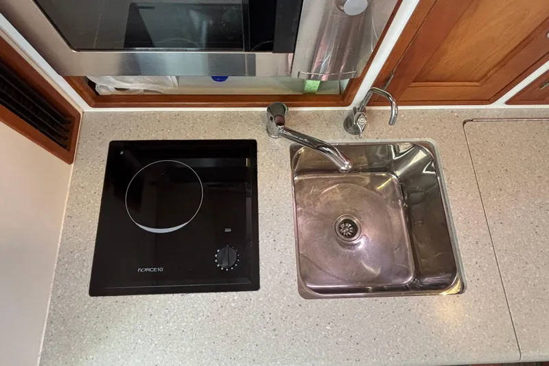 Tango Yacht Photos Pics Compact kitchen area in a 2006 MJM 34z Downeast boat with stove and sink.