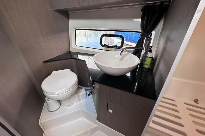  Yacht Photos Pics 2024 Beneteau Flyer 10 bathroom with modern sink, toilet, and window view.