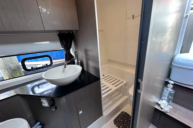  Yacht Photos Pics Modern bathroom interior of 2024 Beneteau Flyer 10 boat, featuring sleek sink and shower area.