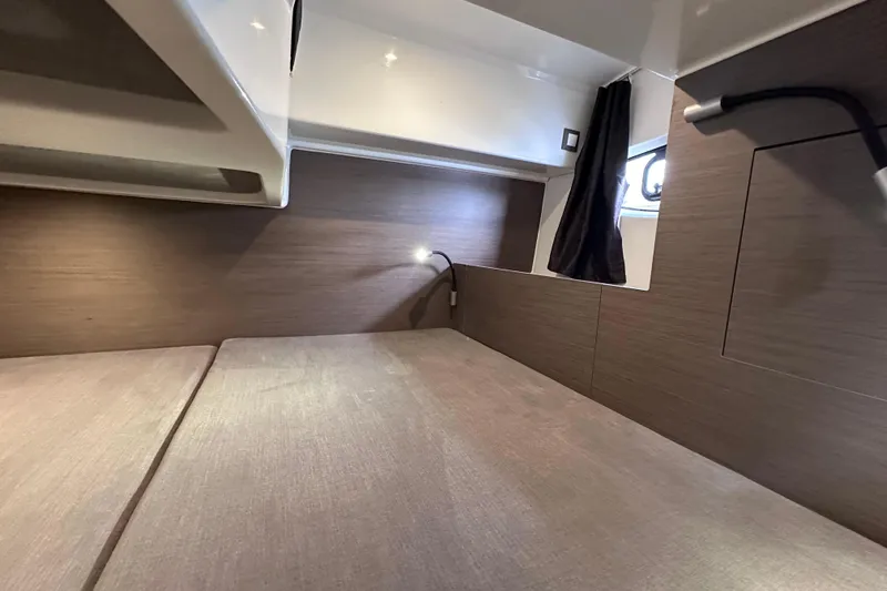 Yacht Photos Pics 2024 Beneteau Flyer 10 cabin interior with modern wood finish and cozy lighting.