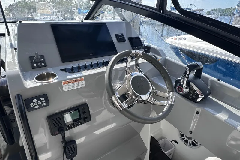  Yacht Photos Pics 2024 Beneteau Flyer 10 helm with modern controls and navigation equipment.