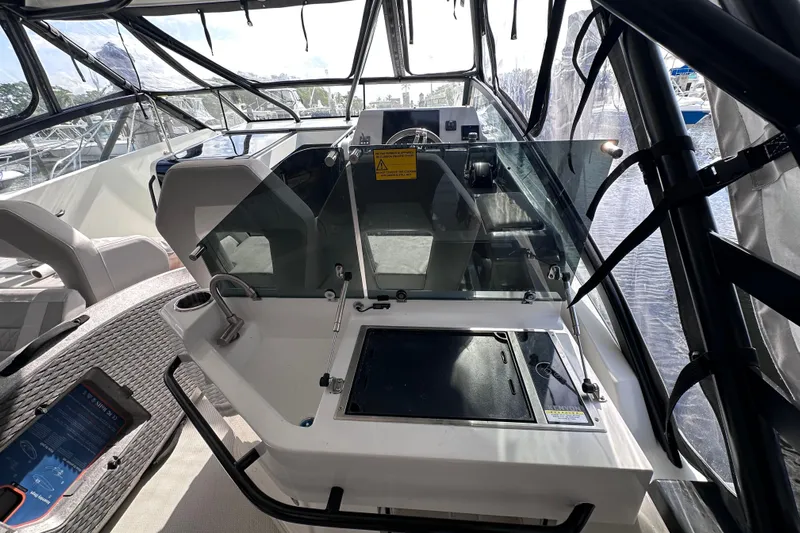  Yacht Photos Pics 2024 Beneteau Flyer 10 cockpit with modern controls and seating, featuring sleek design elements.