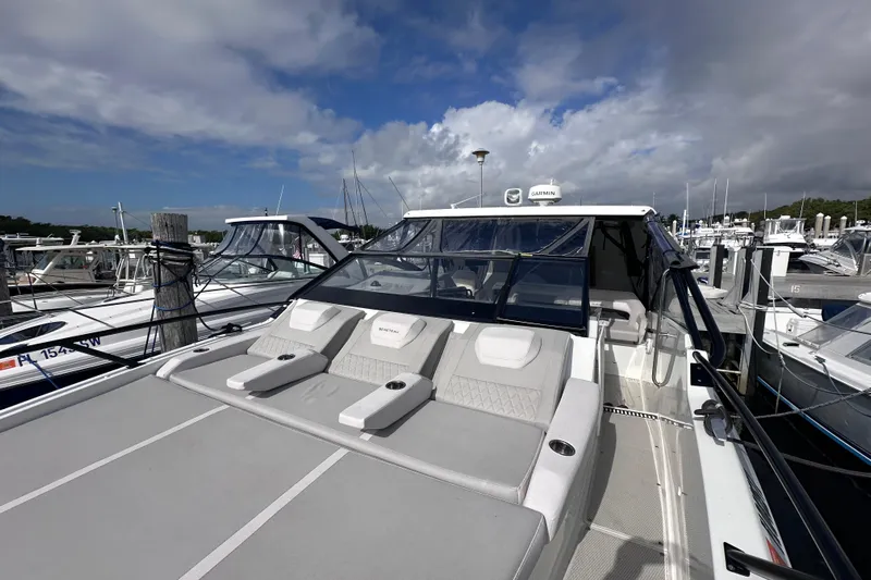  Yacht Photos Pics 2024 Beneteau Flyer 10 yacht docked at marina under cloudy sky.