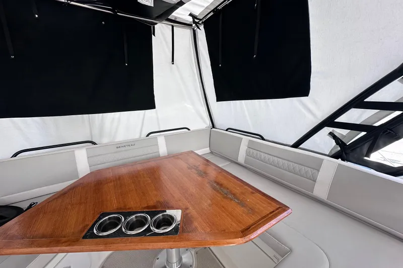  Yacht Photos Pics 2024 Beneteau Flyer 10 interior with wooden table and cushioned seating.