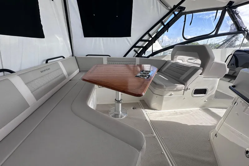  Yacht Photos Pics 2024 Beneteau Flyer 10 interior with elegant seating and wooden table.