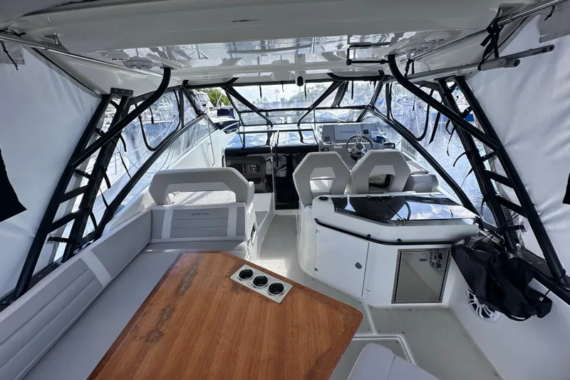  Yacht Photos Pics Interior view of 2024 Beneteau Flyer 10 boat, featuring modern seating and navigation area.