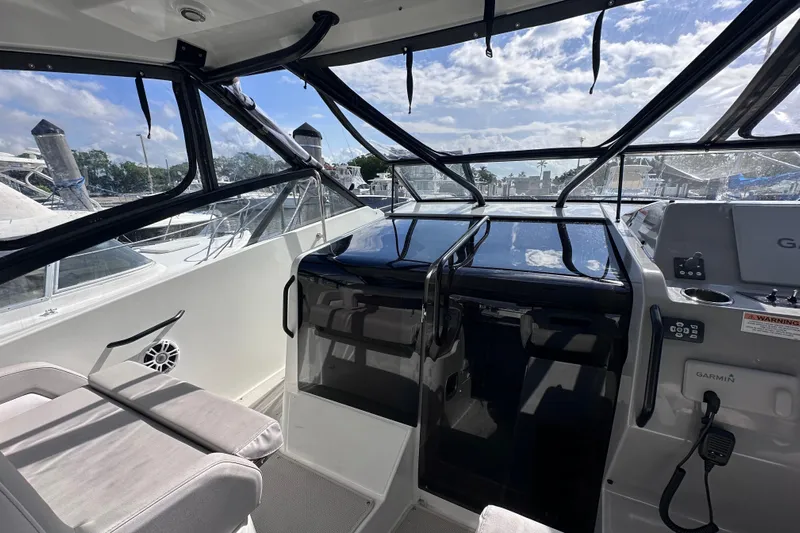  Yacht Photos Pics 2024 Beneteau Flyer 10 cockpit with modern seating and navigation equipment.