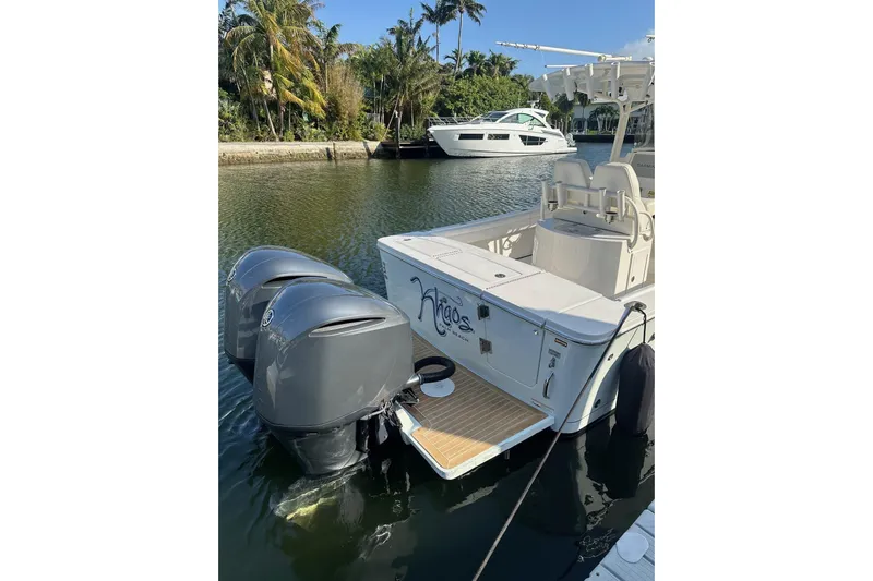  Yacht Photos Pics 2017 Regulator 28 boat with dual outboard motors docked in a scenic marina.