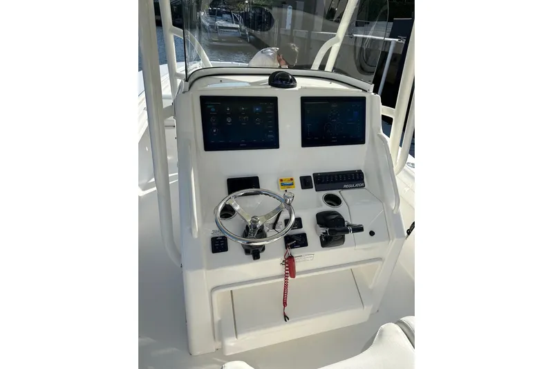  Yacht Photos Pics 2017 Regulator 28 boat helm with dual displays and steering wheel.