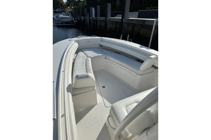  Yacht Photos Pics 2017 Regulator 28 boat with white seating, docked in a marina.