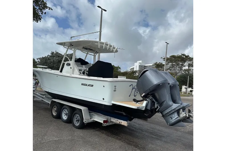  Yacht Photos Pics 2017 Regulator 28 boat on trailer with dual outboard motors, parked outdoors.