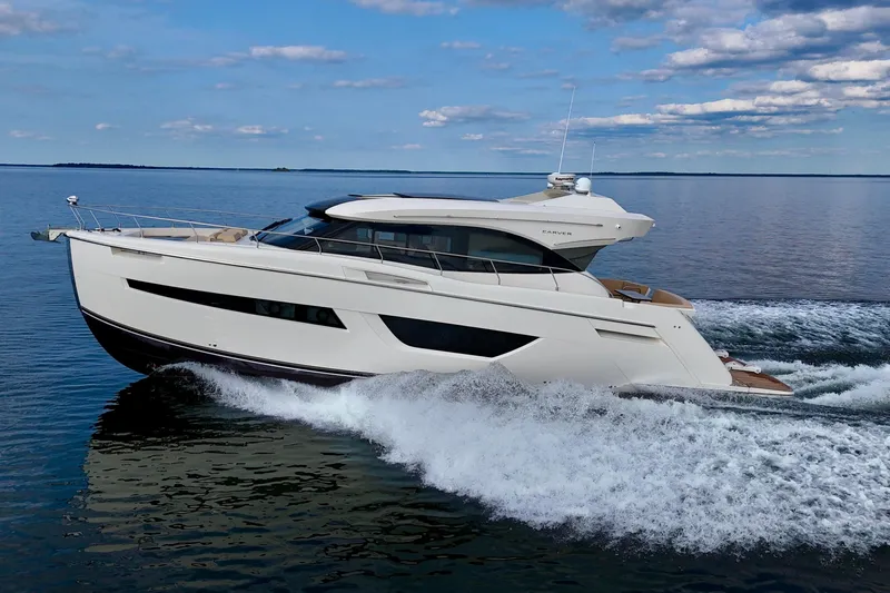Orion Yacht Photos Pics 2018 Carver C52 Coupe yacht cruising on open water under a blue sky.