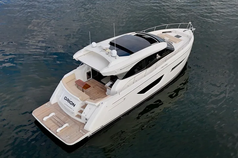 Orion Yacht Photos Pics 2018 Carver C52 Coupe yacht on water, featuring sleek design and spacious deck.