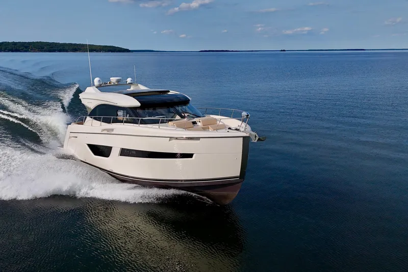 Orion Yacht Photos Pics 2018 Carver C52 Coupe yacht cruising on a serene blue lake.