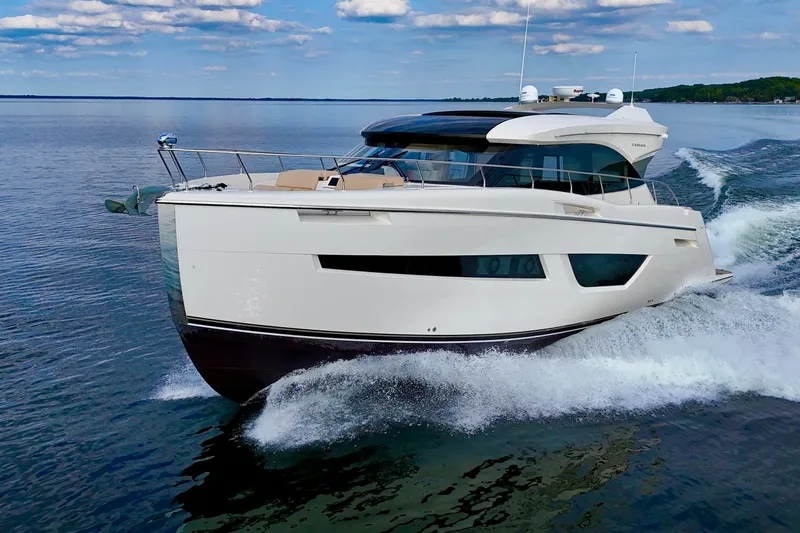 Orion Yacht Photos Pics 2018 Carver C52 Coupe yacht cruising on open water under a clear sky.