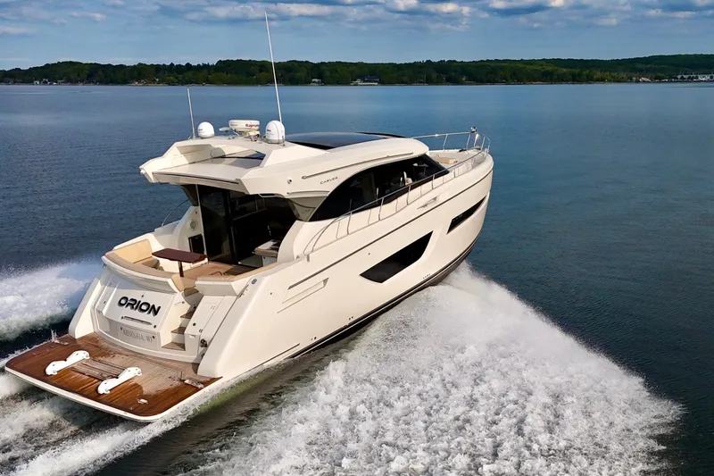Orion Yacht Photos Pics 2018 Carver C52 Coupe yacht cruising on a serene lake.
