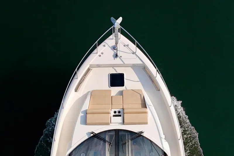 Orion Yacht Photos Pics Top view of 2018 Carver C52 Coupe yacht cruising on water.