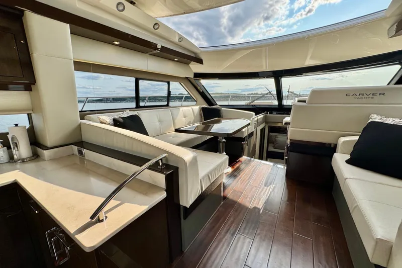 Orion Yacht Photos Pics Luxurious interior of 2018 Carver C52 Coupe yacht with elegant seating and panoramic windows.