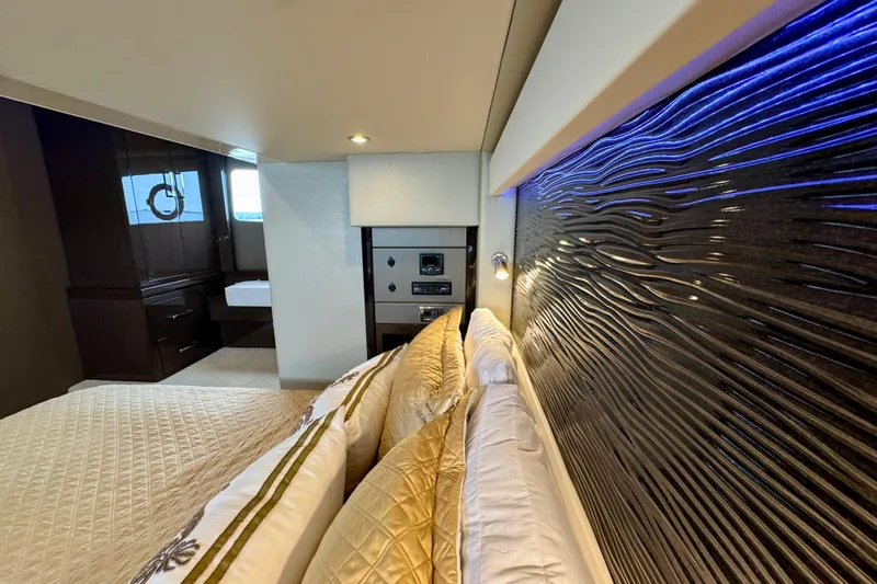 Orion Yacht Photos Pics Luxurious interior of 2018 Carver C52 Coupe yacht with elegant bedding and modern design.