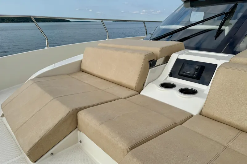 Orion Yacht Photos Pics Luxurious seating on 2018 Carver C52 Coupe yacht with control panel and cup holders.