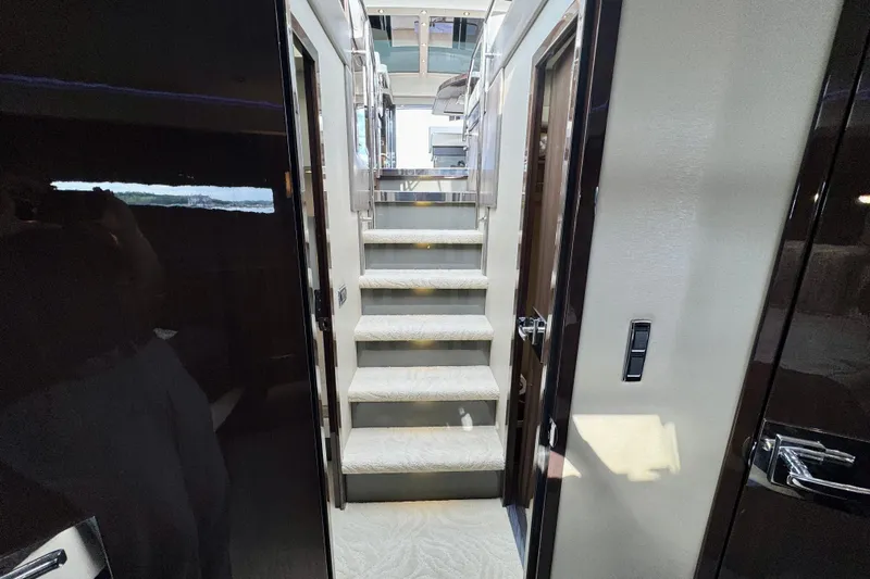 Orion Yacht Photos Pics Interior view of 2018 Carver C52 Coupe yacht, featuring elegant staircase and modern design.