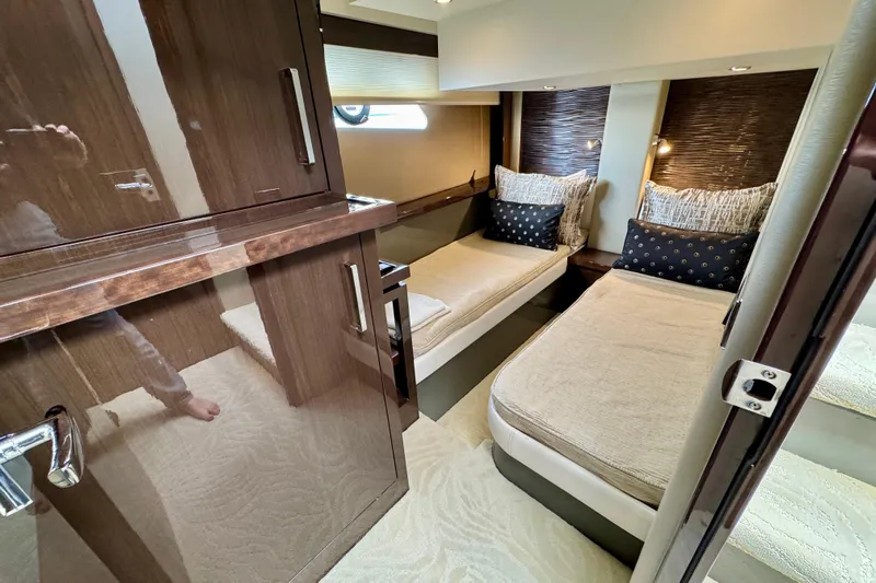 Orion Yacht Photos Pics Luxurious interior of 2018 Carver C52 Coupe yacht with twin beds and elegant wood finishes.